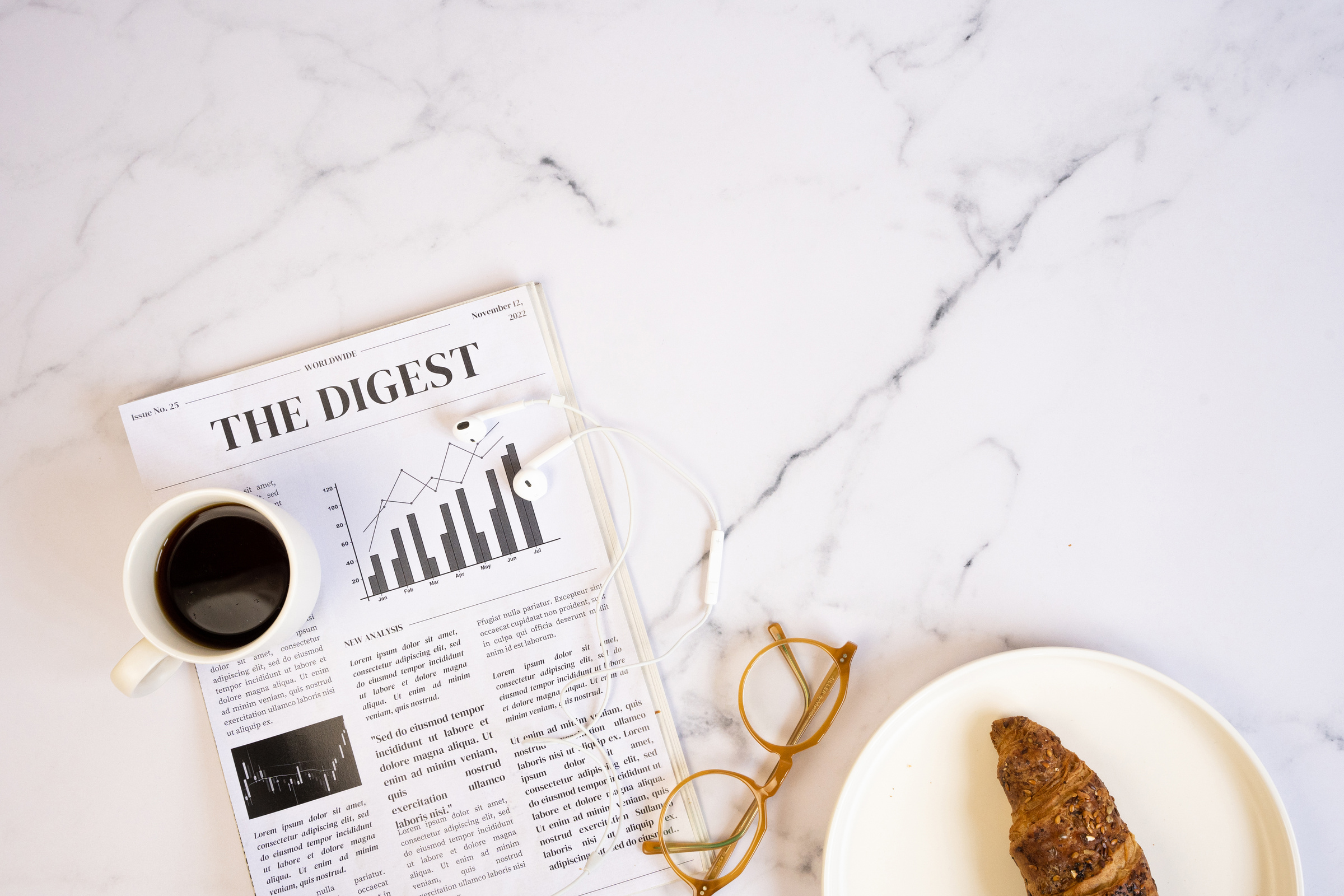 Newspaper with Coffee and Croissant on White Marble Table